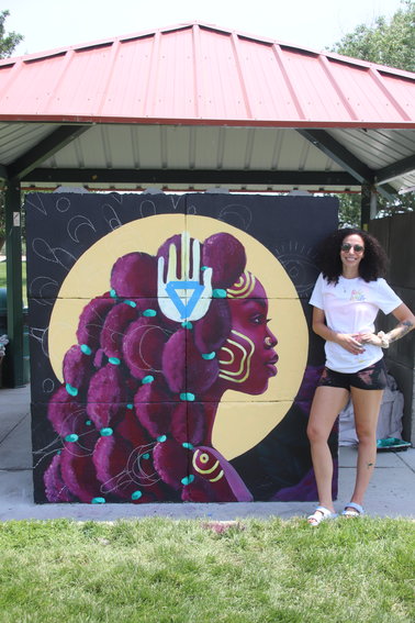 Babe Walls member Jahna Rae poses in front of her mural.